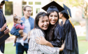 Graduate hugging family member at celebration.