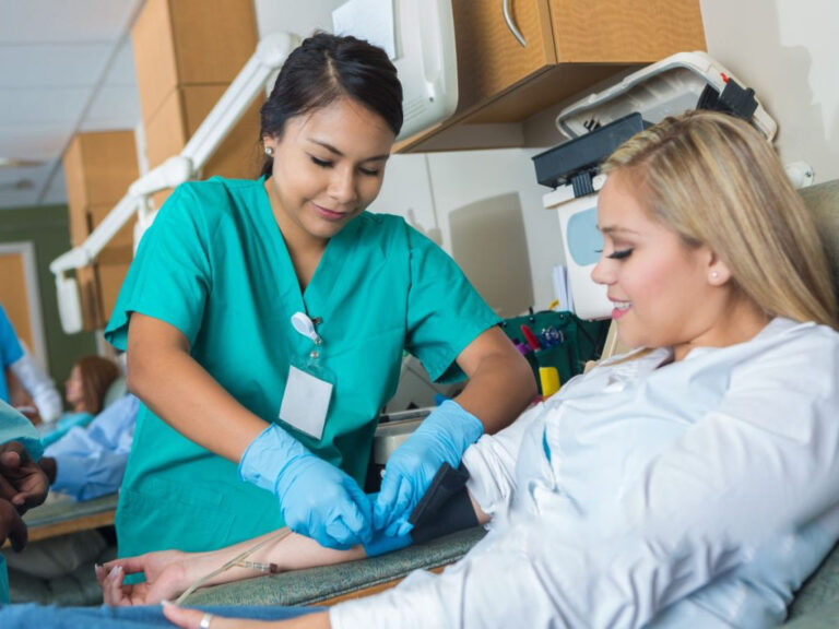 Nurse drawing blood from a patient.