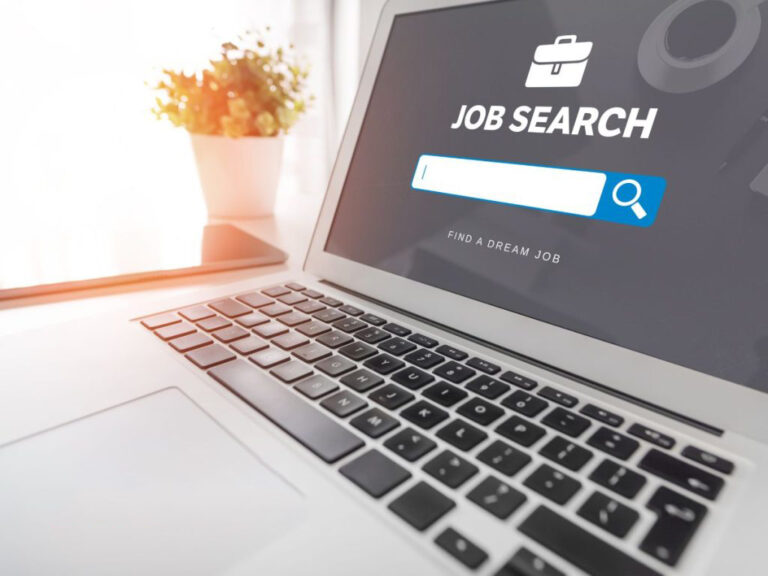 Laptop displaying job search website interface.