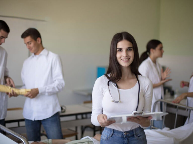 Medical students with stethoscope in classroom.
