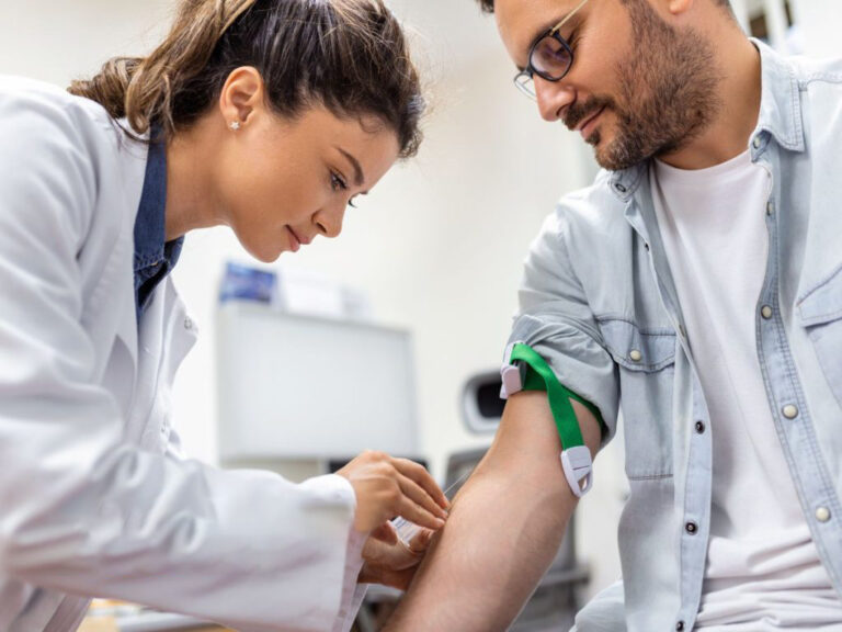 Doctor preparing patient for blood test.
