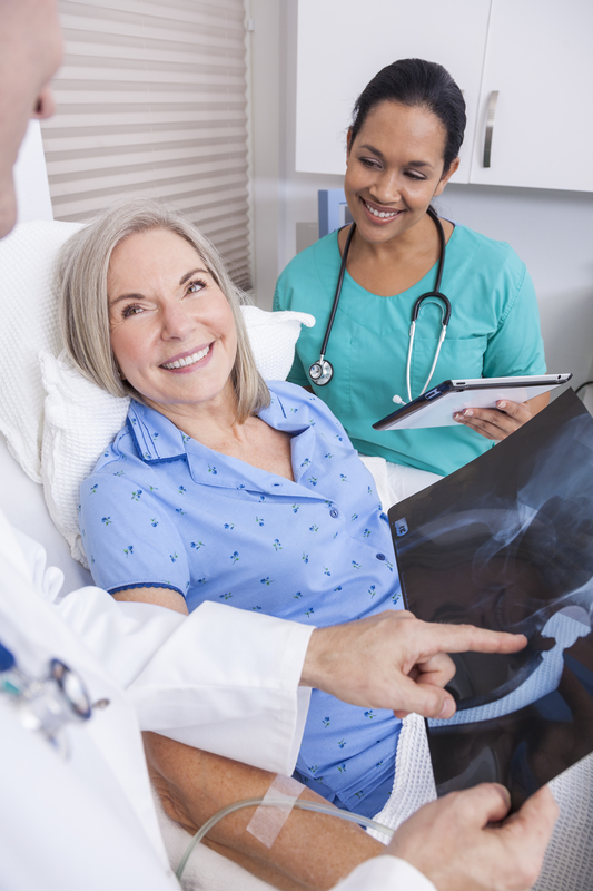 Patient discussing X-ray results with medical staff.