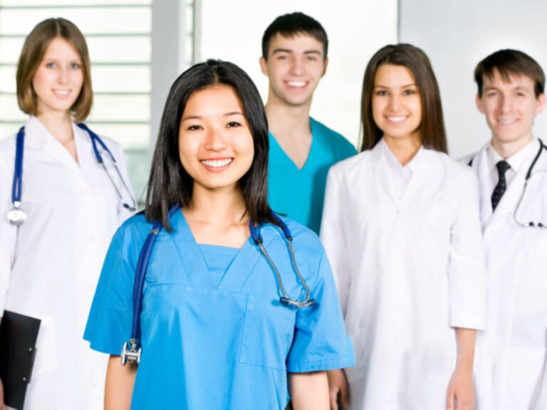 Group of smiling medical professionals in uniforms.