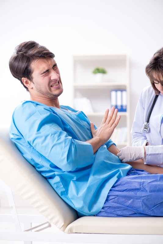 Man in pain during medical procedure.