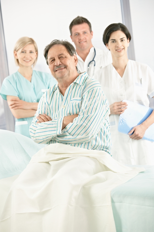 Patient with medical team in hospital room.
