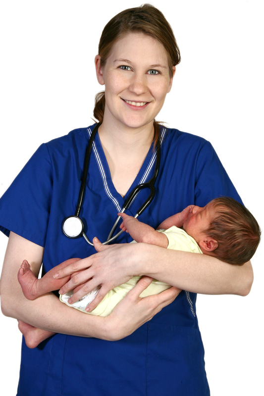 Nurse holding a newborn baby, smiling.