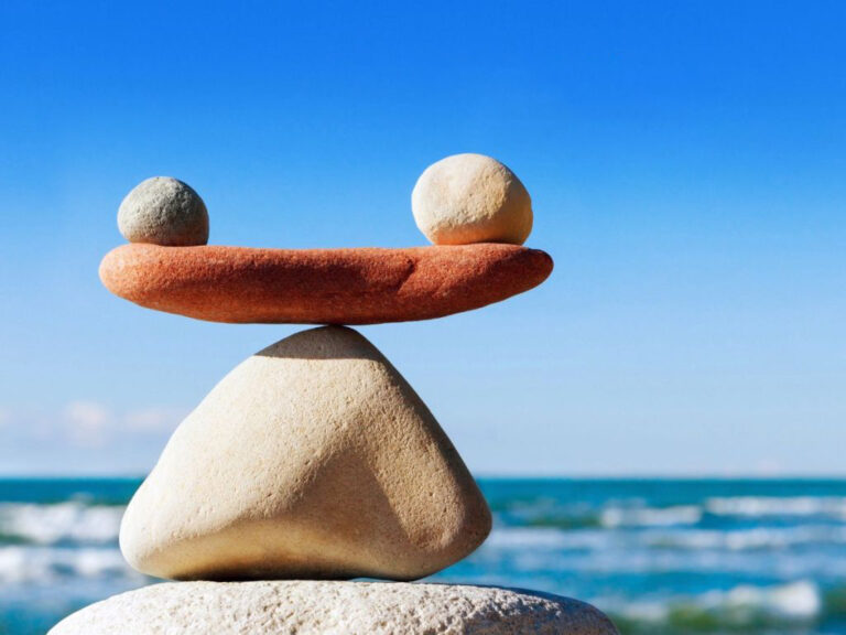 Balanced stones with ocean background.