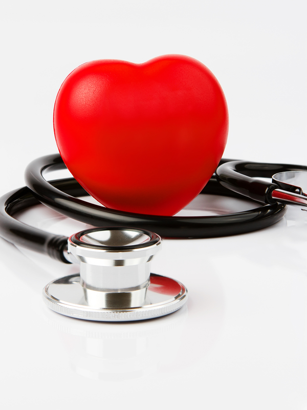 Red heart and stethoscope on white background.