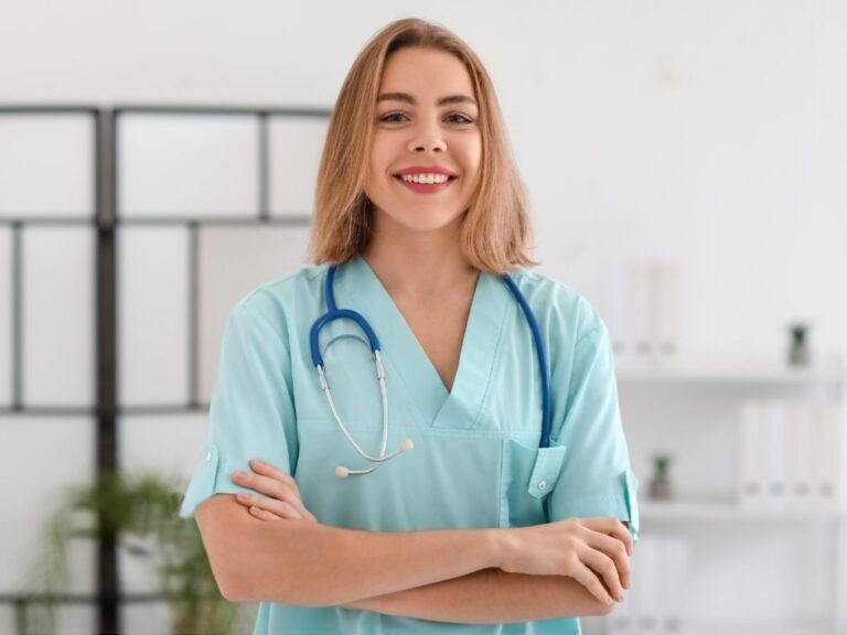 Smiling nurse with stethoscope in clinic.