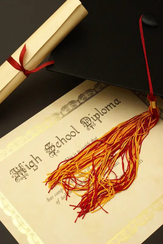 Graduation cap and diploma with tassel.