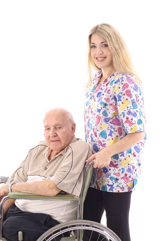 Elderly man in wheelchair with smiling caregiver.